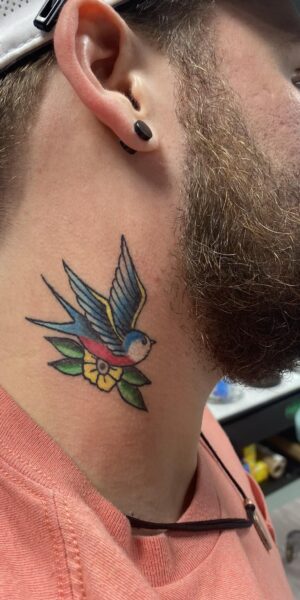 Color Neck Tattoo Artwork Color tattoo design placed on the side of the neck featuring bold lines and shading