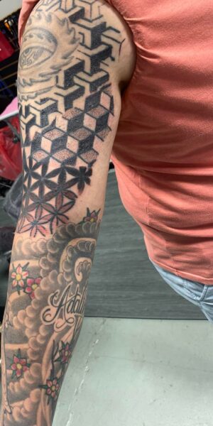Geometric Sleeve Tattoo Geometric tattoo sleeve design with repeating patterns and detailed linework