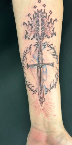 Cross and Symbol Tattoo Symbolic tattoo design featuring a cross and ornamental details