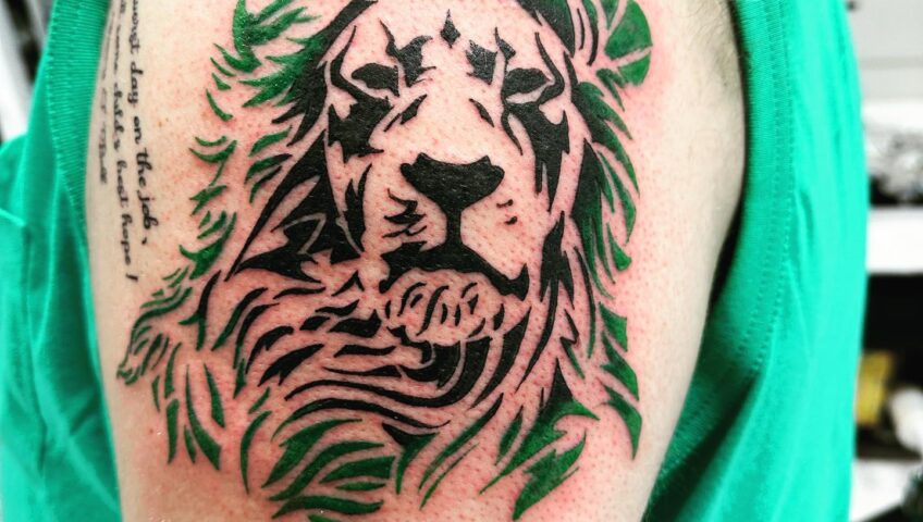 Lion tattoo design with bold linework and expressive details