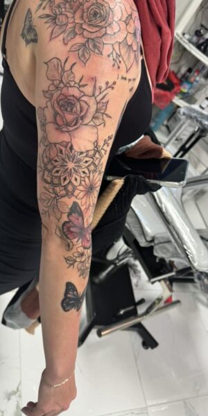 Floral and Botanical Tattoo Botanical tattoo design featuring flowers and leaves