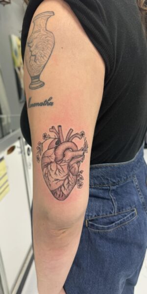 Floral Tattoo on Arm Floral tattoo design with clean linework on the upper arm