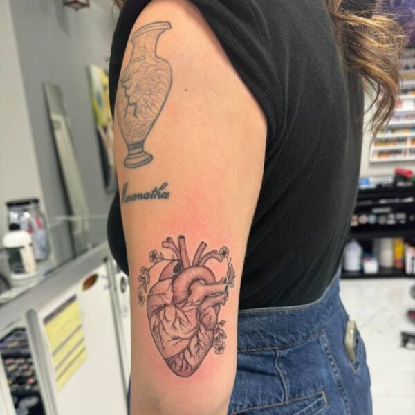 Happy client shows custom tattoo at woman-owned tattoo shop Youngsville LA