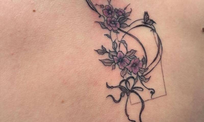 Fine line floral tattoo design featuring delicate linework and detailed shading