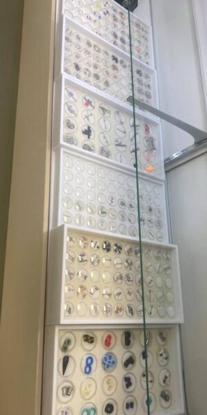 Piercing jewelry displayed inside a well-lit cabinet at Inkophilia