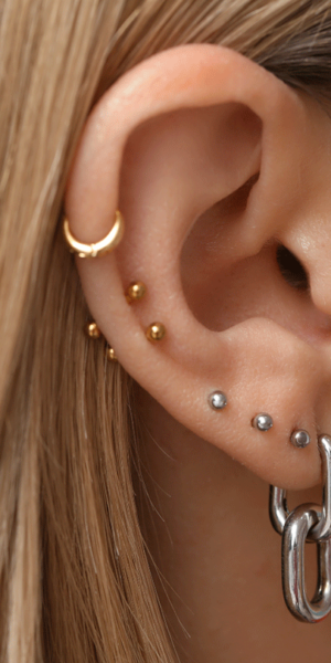 piercing jewelry Happy client shows custom piercing at woman-owned tattoo shop Youngsville LA